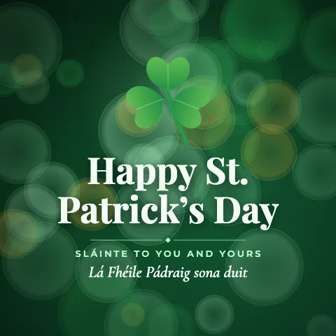 Happy St. Patrick’s Day greeting image in bokeh lights style with the wish “Sláinte to you and yours” and the greeting in Irish