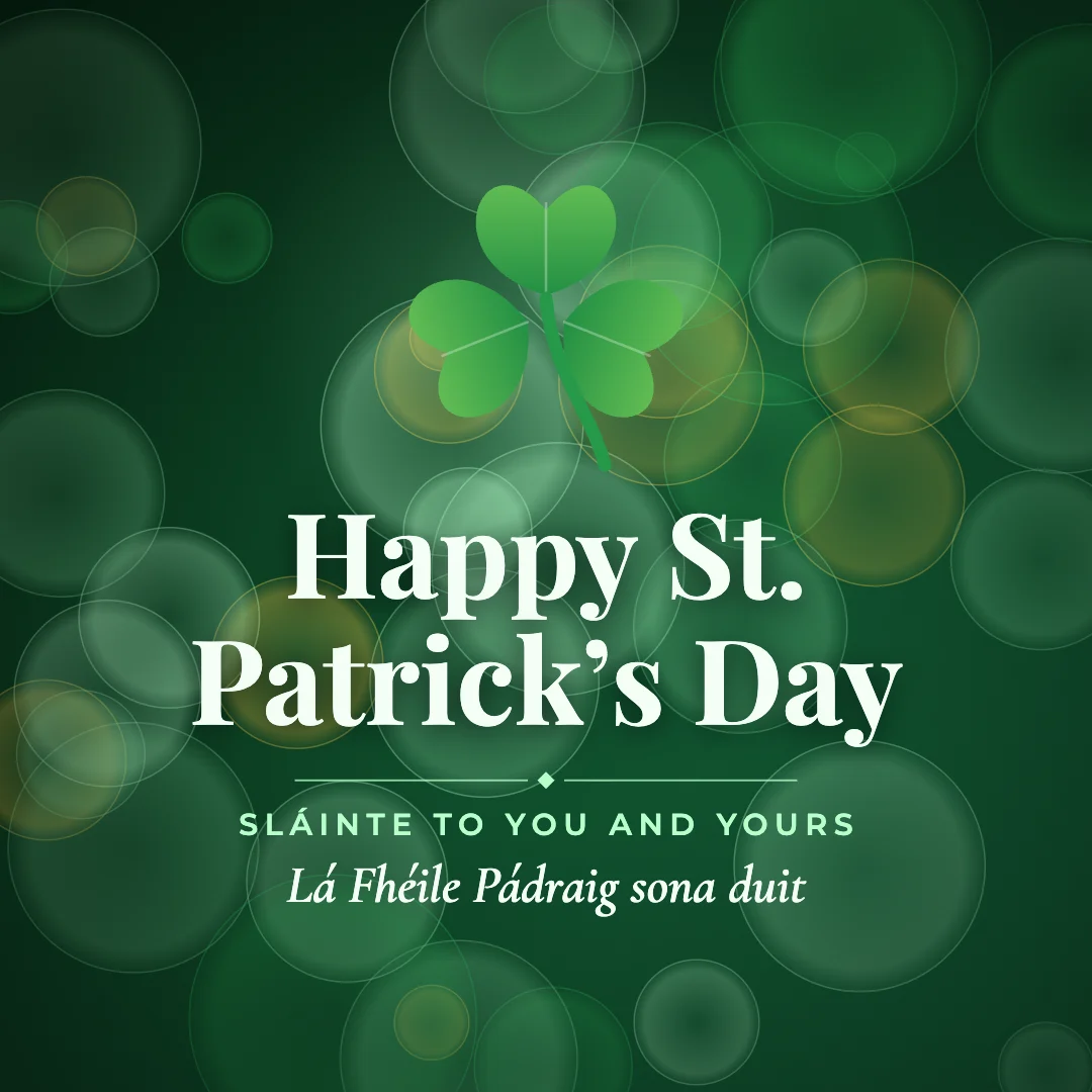 Happy St. Patrick’s Day greeting image in bokeh lights style with the wish “Sláinte to you and yours” and the greeting in Irish